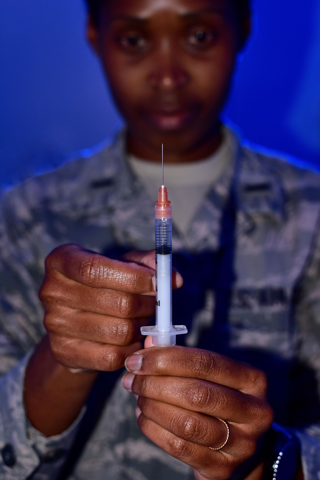 An immunizations clinic officer prepares a vaccine to administer to a service member March 2, 2017 at the Clinic on Little Rock Air Force Base, Ark.  The Immunization clinic provides thousands of vaccines monthly to service members and their families.  (U.S. Air Force by Staff Sgt. Jeremy McGuffin)