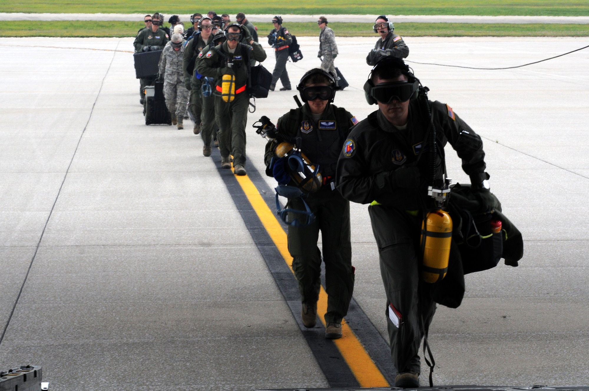 Crew members of the 445th Aeromedical Evacuation Squadron begin to board a C-130 Hercules with their equipment for a joint training mission here, June 7, 2017. The 445th AES participated in a joint training mission with the 910th Airlift Wing and the 914th Airlift Wing. (U.S. Air Force photo/Senior Airman Joshua Kincaid)