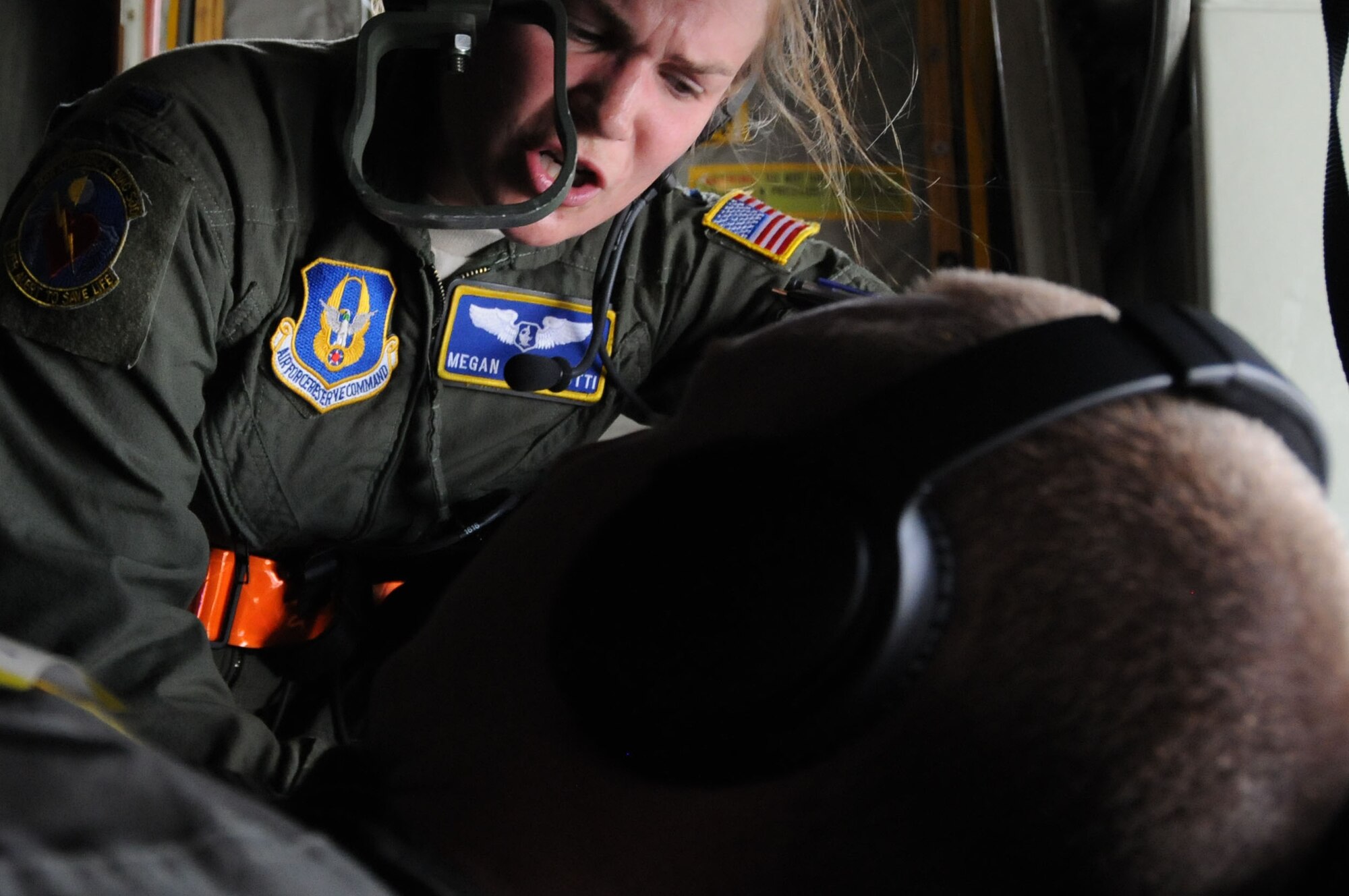 1st Lt. Megan Mancinotti, a crew member with the 445th Aeromedical Evacuation Squadron here, gives instructions to a Citizen Airman simulating a patient for a joint training mission here, June 7, 2017. The 445th AES trained for two hours while airborne to simulate a real-world scenario. (U.S. Air Force photo/Senior Airman Joshua Kincaid)