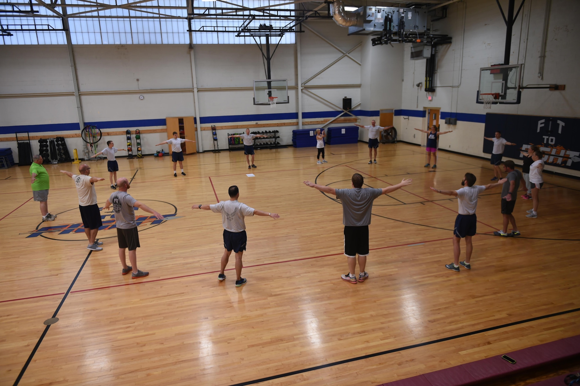 U.S. Air Force Senior Airman Nathan Clark, 97th Air Mobility Wing photojournalist, prepares the 2017 Altus Air Force Base honorary commanders for their morning physical training session, May 31, 2017 at Altus Air Force Base, Oklahoma. The honorary commanders spent the morning working out with active duty members to experience the importance of physical fitness to our armed forces. (U.S. Air Force Photo by Senior Airman Kirby Turbak/Released.)