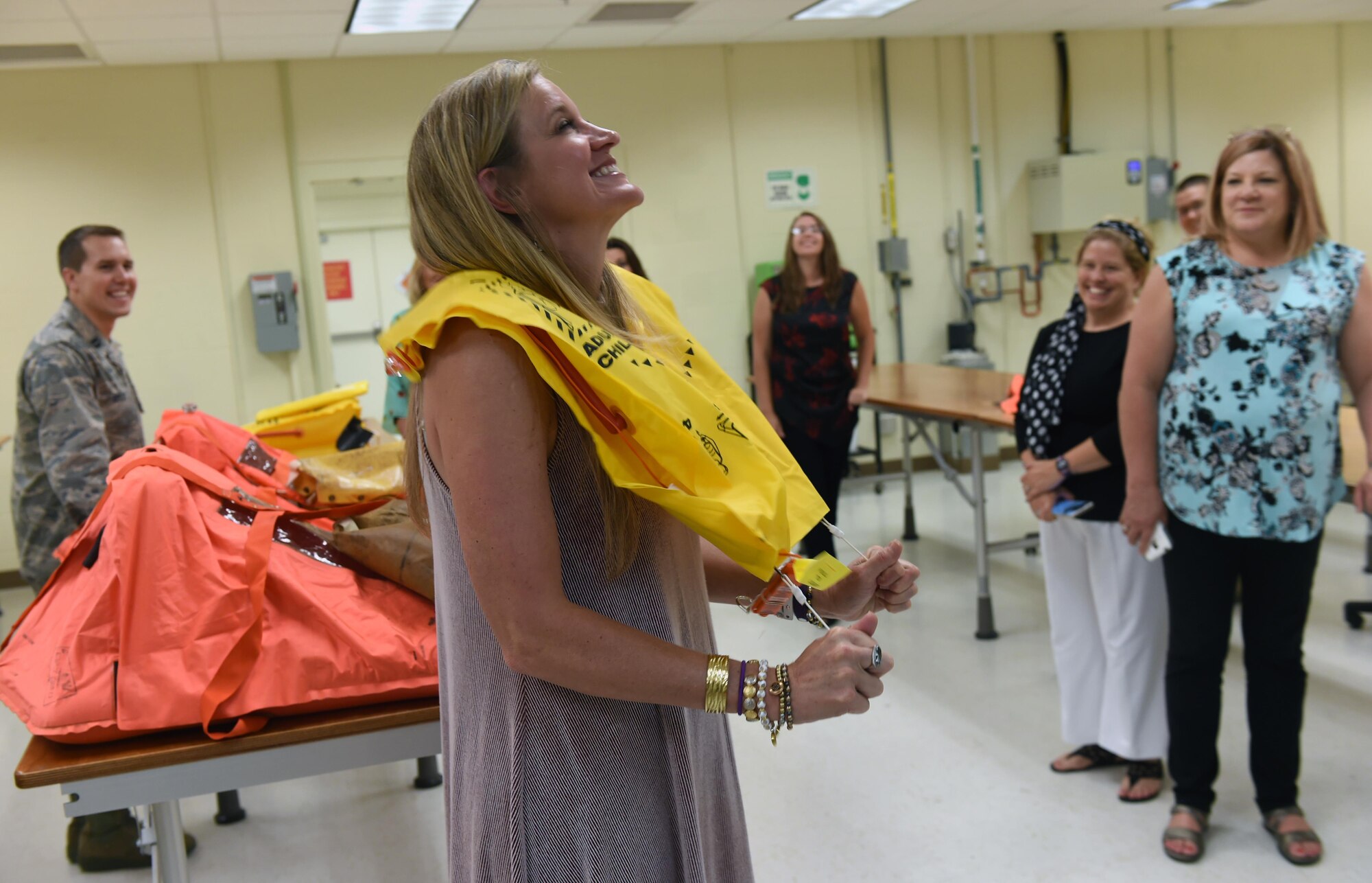 Kelley Duncan, 97th Mission Support Group honorary commander inflates a life vest during a tour of the Aircrew Flight Equipment squadron, May 31, 2017 at Altus Air Force Base, Oklahoma. The honorary commanders spent the day discovering the different mission sets at Altus AFB. (U.S. Air Force Photo by Senior Airman Kirby Turbak/Released.)