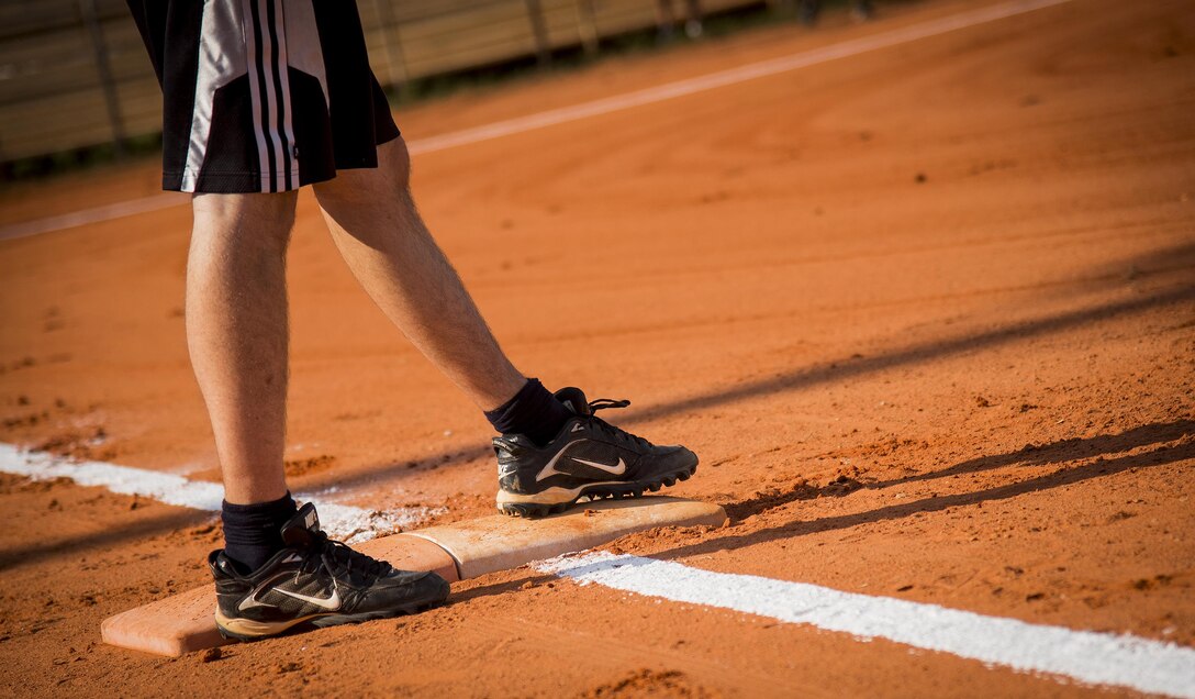 A runner steps on first base during an intramural softball game at Eglin Air Force Base, Fla., June 8.  The Armament Directorate team bashed the hapless Air Force Research Lab team 14-4 in five innings of play.  (U.S. Air Force photo/Samuel King Jr.)