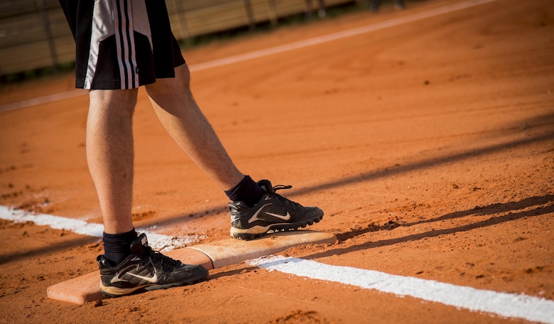 A runner steps on first base during an intramural softball game at Eglin Air Force Base, Fla., June 8.  The Armament Directorate team bashed the hapless Air Force Research Lab team 14-4 in five innings of play.  (U.S. Air Force photo/Samuel King Jr.)