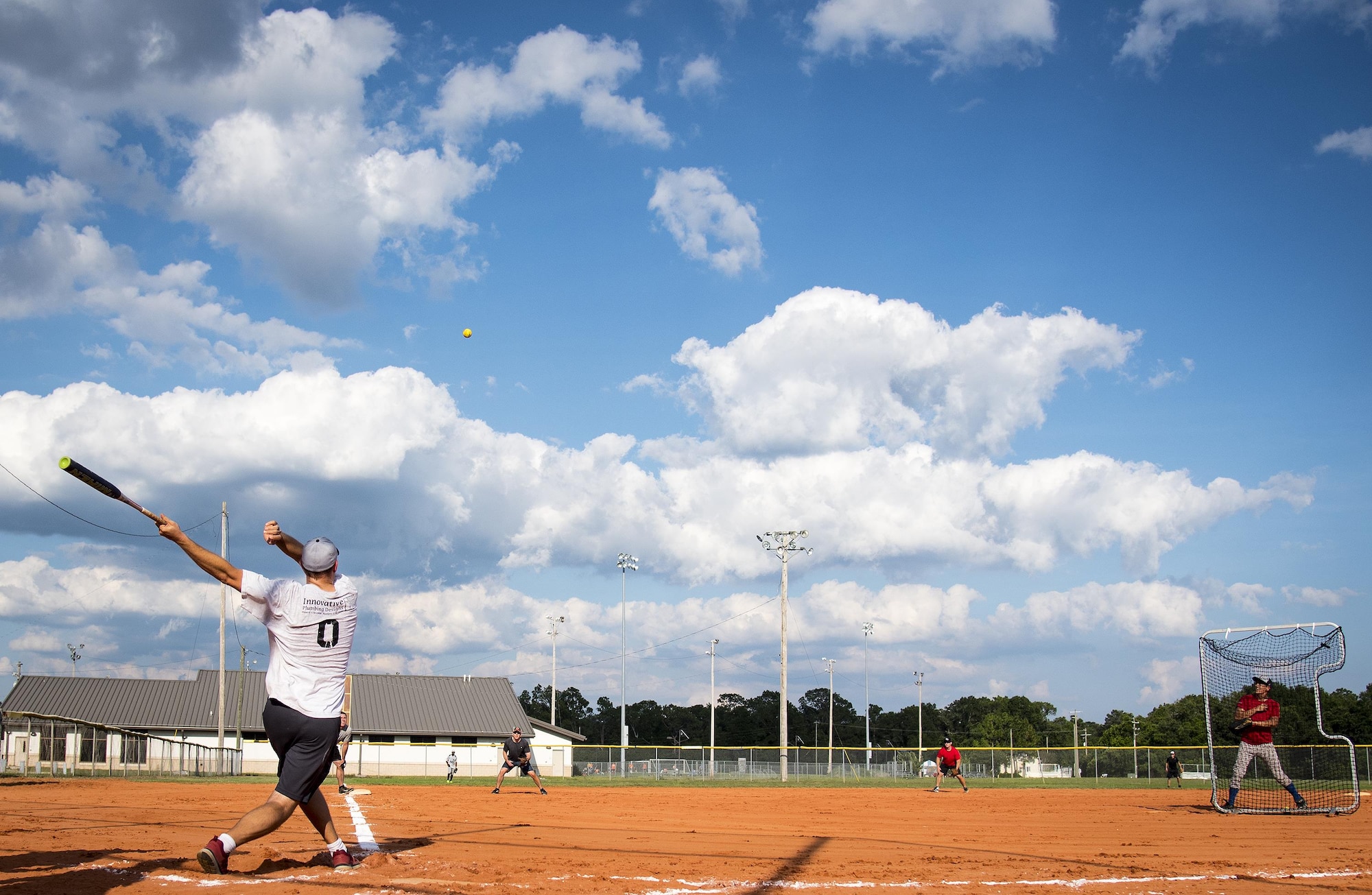 An Armament Directorate team member swings for the fences during an intramural softball game at Eglin Air Force Base, Fla., June 8.  The EB team bashed the hapless Air Force Research Lab team 14-4 in five innings of play.  (U.S. Air Force photo/Samuel King Jr.)
