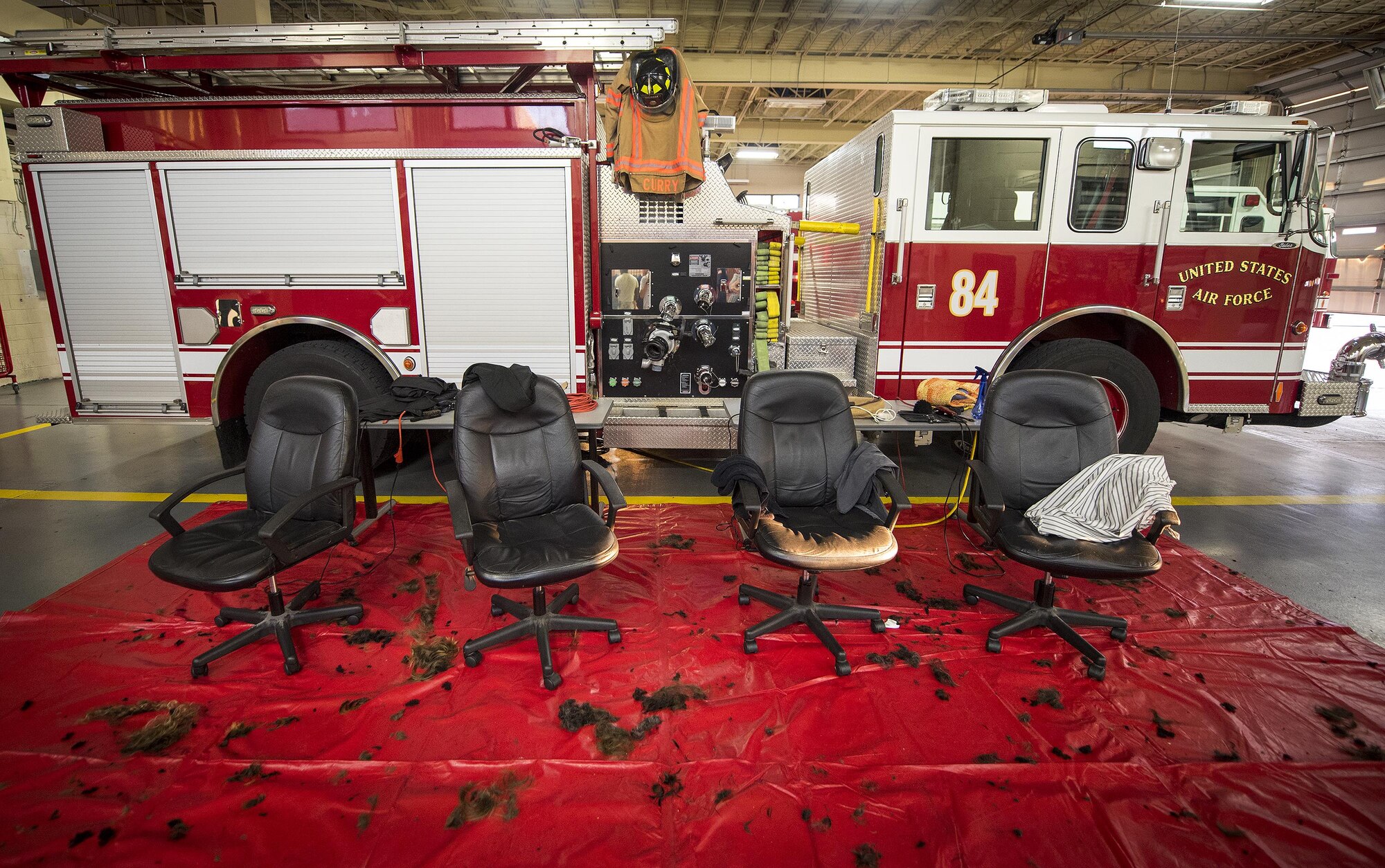 The hair from approximately 20 firefighter’s heads covers the floor of Fire Station 1 June 8 at Eglin Air Force Base, Fla.  Approximately 20 firefighters shaved their heads to raise awareness and funds for their crew mate, Terrance Curry, whose battled cancer continuously for 11 months.  (U.S. Air Force photo/Samuel King Jr.)