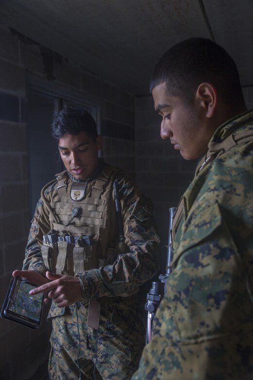 Cpl. Daniel A. Reyes (left), a joint fires observer with 3rd Brigade, 3rd Air Naval Gunfire Liaison Company, Force Headquarters Group, Marine Forces Reserve, points out target coordinates on his tablet to Lance Cpl. Romaldo Medina (left), a forward observer with 3rd Brigade, 3rd ANGLICO, at the Canadian Manoeuvre Training Centre, in Wainwright, Alberta, Canada, during exercise Maple Resolve 17, May 25, 2017. The mission of 3rd ANGLICO is to provide the Marine Air Ground Task Force commanders a liaison capability to plan, coordinate, and conduct terminal control of fires in support of joint, allied, and coalition forces. (U.S. Marine Corps Photo by Lance Cpl. Niles Lee/Released)