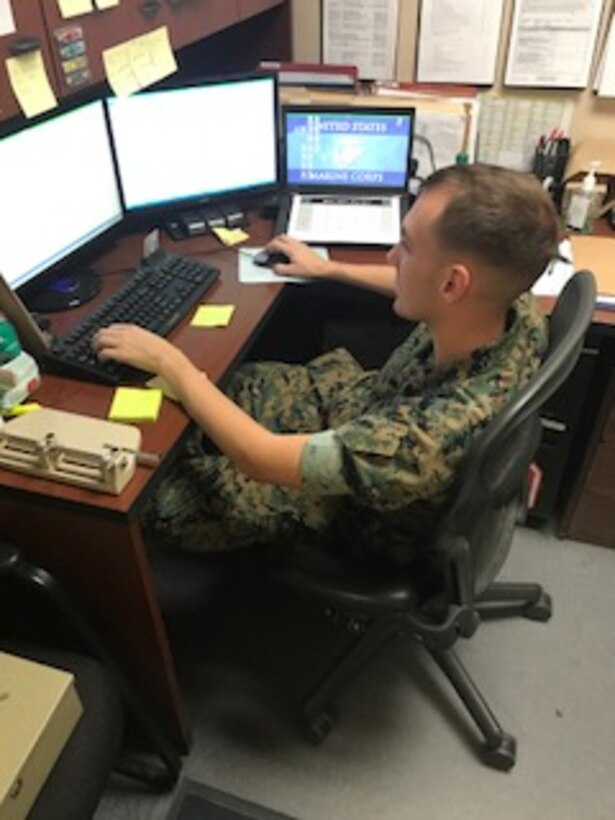 As the Training Chief for HqCo, Sgt James Matthews is shown inputing PFT scores into MCTIMS data bank. 