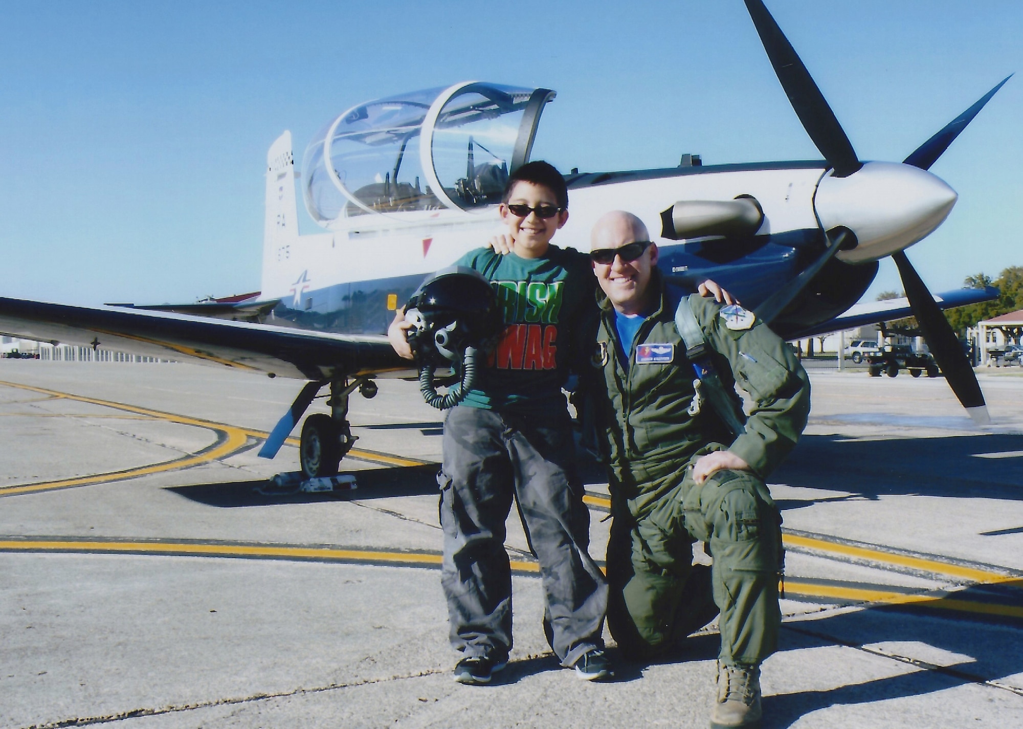 Lt. Col. Andrew "Kisser" Kissinger, 39th Flying Training Wing T-6 Texan instructor pilot poses with his son Nicholas Kissinger in front of a T-6 Texan at JBSA-Randolph. 