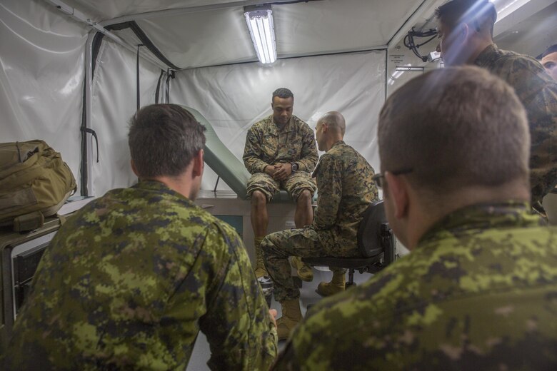 COLD LAKE, AB, CANADA – U.S. Navy Lt. Cmdr. Christian Basque, a navy doctor with Marine Wing Support Squadron 472, Marine Aircraft Group 49, 4th Marine Aircraft Wing, Marine Forces Reserve, shows pictures of X-rays from his civilian job as a sports medicine physician to Canadian medical technicians during exercise Maple Flag 50 at Canadian Forces Base Cold Lake, Alberta, June 2, 2017. Maple Flag is an annual multi-national training exercise hosted by the Royal Canadian Air Force with foreign nations training together to complete simulated combat missions. (U.S. Marine Corps photo by Lance Cpl. Niles Lee/Released)