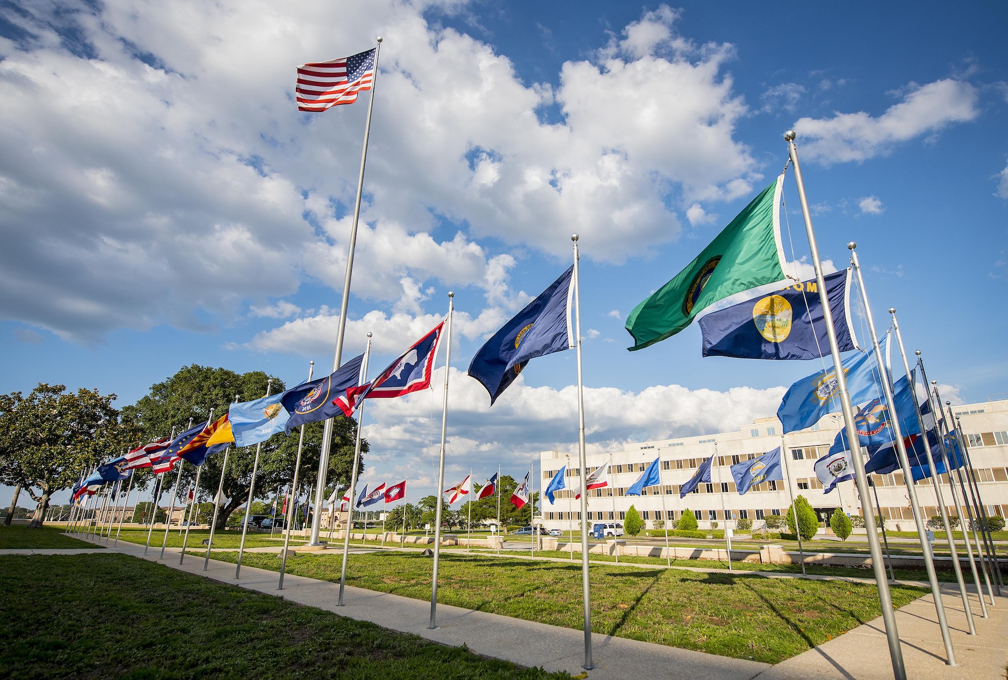 Flags of every state and the American flag flap in the breeze in front of the 96th Test Wing headquarters building.  Flag Day is celebrated in America on June 14.  National Flag Day began in 1949 and commemorates the adoption of the U.S. Flag on June 14, 1777. (U.S. Air Force photo/Samuel King Jr.)
