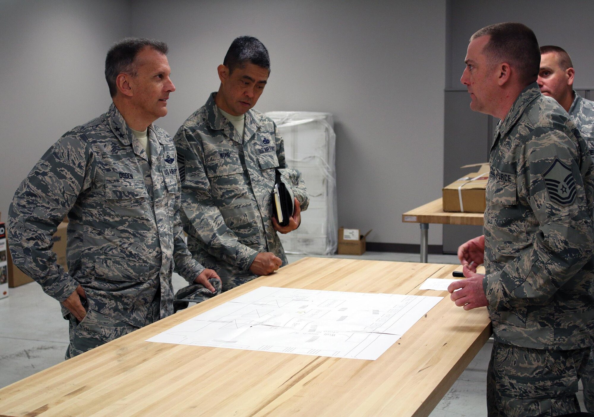 Master Sgt. Anthony Phillips, 445th Civil Engineer Squadron HVAC craftsman, and Senior Master Sgt. Karl Morgan, operations superintendent, give Maj. General Randall Ogden, 4th Air Force commander, and Chief Master Sgt. Brian Wong, 4th Air Force command chief, a tour of the CES’s building that was recently renovated during their visit to the unit May 20, 2017. (U.S. Air Force photo/Tech. Sgt. Patrick O’Reilly)