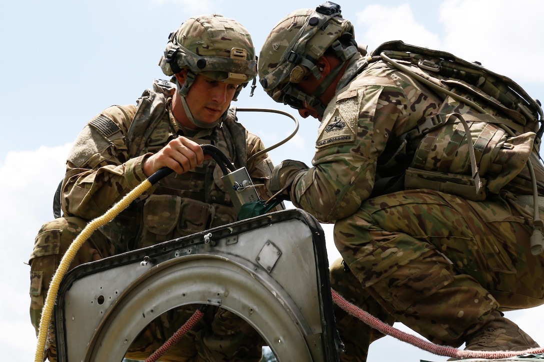 Soldiers assigned to 1st Battalion, 501st Aviation Regiment, attach a rope to a simulated downed UH-72 Lakota helicopter while conducting vehicle recovery operations during Exercise Combined Resolve VIII at Hohenfels Training Area, Germany, June 8, 2017. Army photo by Spc. Michael Bradley