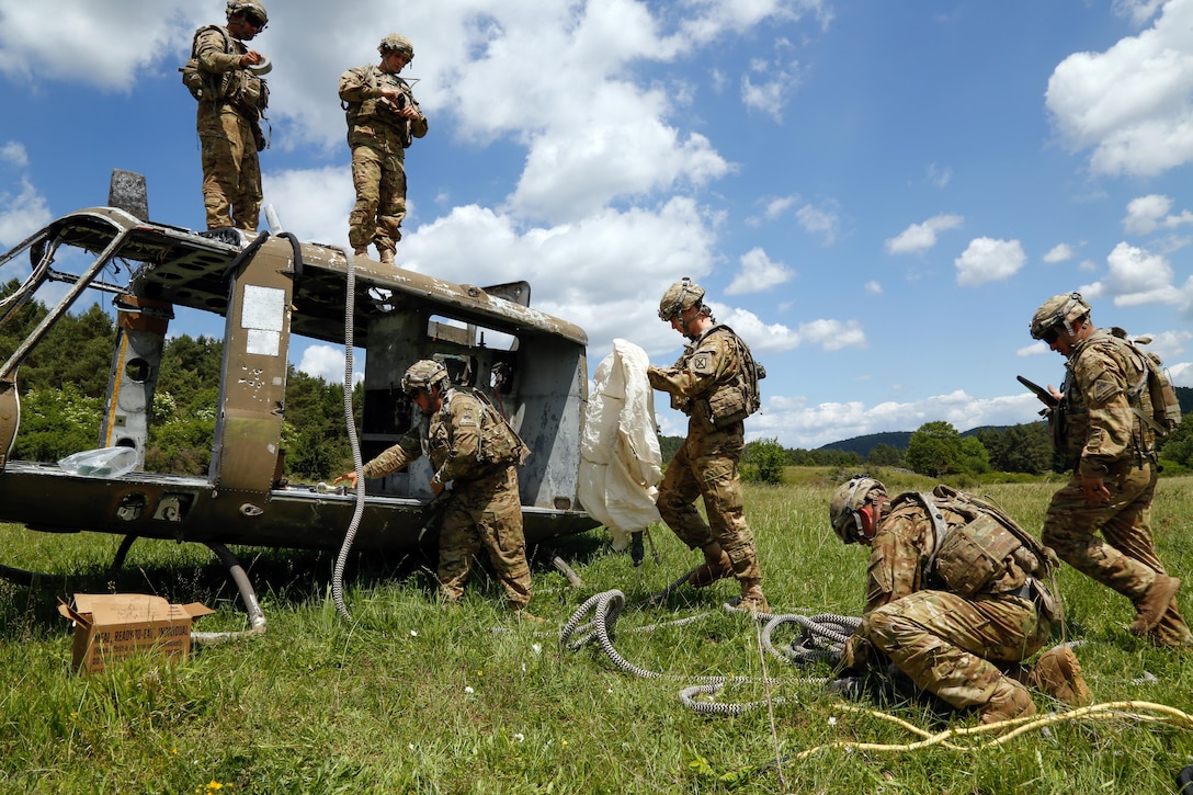 Soldiers assigned to 1st Battalion, 501st Aviation Regiment, attach a rope to a simulated downed UH-72 Lakota helicopter while conducting vehicle recovery operations during Exercise Combined Resolve VIII at Hohenfels Training Area, Germany, June 8, 2017. Army photo by Spc. Michael Bradley