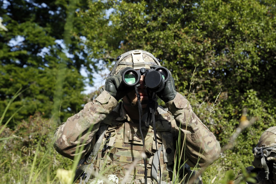 A soldier assigned to 1st Battalion, 501st Aviation Regiment, peers through field binoculars during Exercise Combined Resolve VIII at Hohenfels Training Area, Germany, June 8, 2017. Exercise Combined Resolve VIII is a multinational exercise designed to train the Army’s Regionally Allocated Force for the U.S. European Command. Army photo by Spc. Michael Bradley