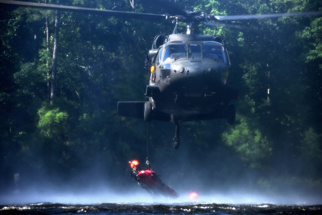 A South Carolina Army National Guardsman is hoisted onto a UH-60L Black Hawk helicopter during rescue training at the South Carolina Fire Academy campus, Columbia, S.C., June 2, 2017. Army National Guard photo by Staff Sgt. Roberto Di Giovine