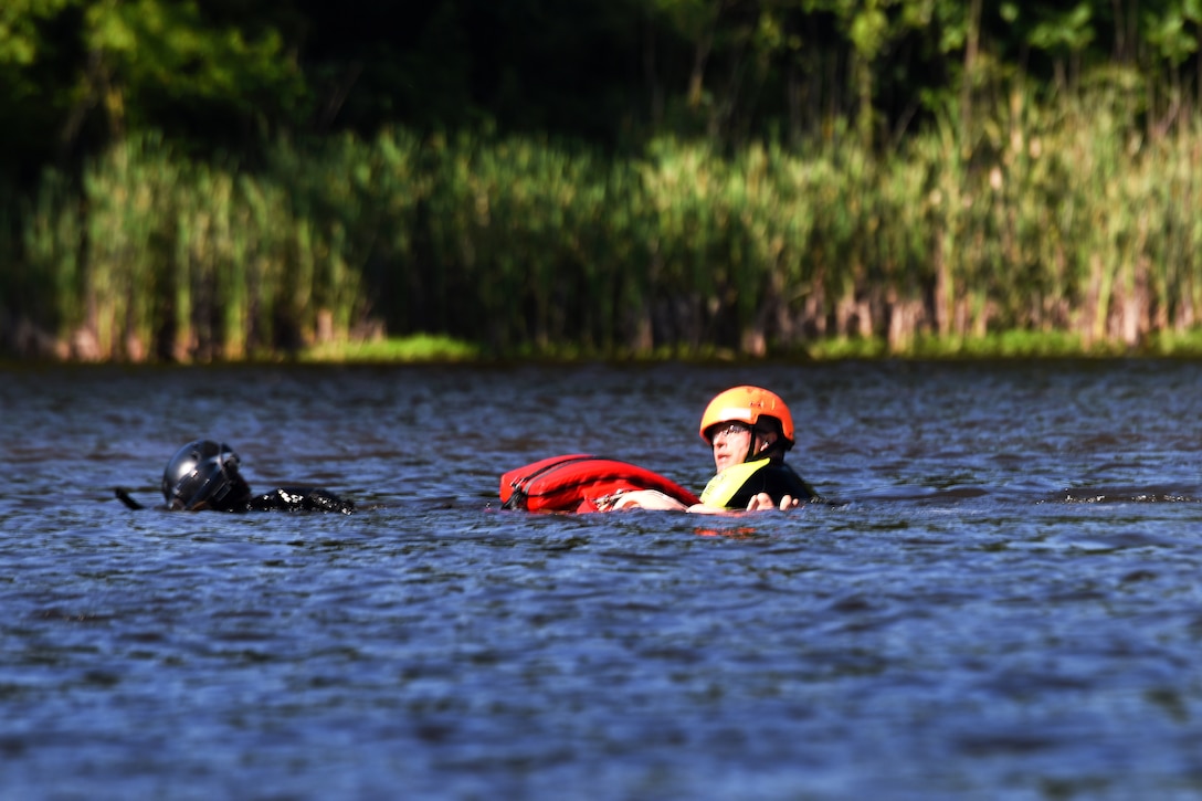 A South Carolina Army National Guardsman and fire department rescuer from the Helicopter Aquatic Rescue Team, treads water awaiting  Black Hawk helicopter rescue at the South Carolina Fire Academy campus, Columbia, S.C., June 2, 2017. Army National Guard photo by Staff Sgt. Roberto Di Giovine