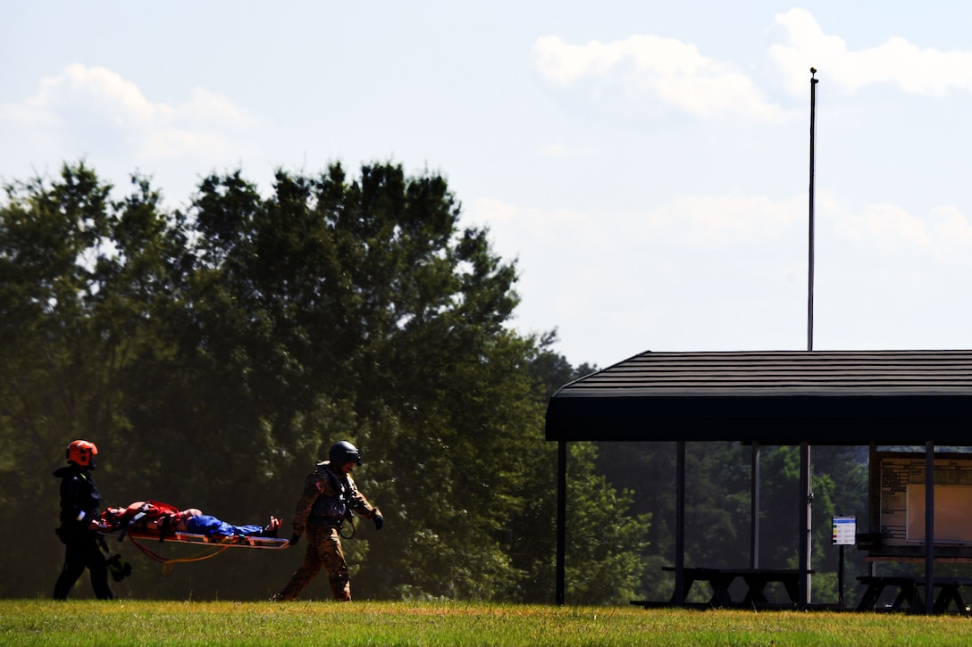 Rescuers from the Helicopter Aquatic Rescue Team, carry a mannequin on a stretcher to a casualty collection point during rescue training at the South Carolina Fire Academy campus, Columbia, S.C., June 2, 2017. Army National Guard photo by Staff Sgt. Roberto Di Giovine