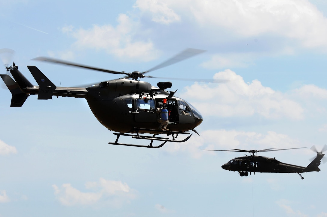 A LUH-72A light, utility-helicopter passes a UH-60L Black Hawk helicopter during rescue training at the South Carolina Fire Academy campus, Columbia, S.C., June 2, 2017. Army National Guard photo by Staff Sgt. Roberto Di Giovine