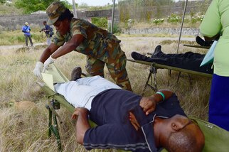 170610-N-CM227-190 Fire officers from the Bridgetown Fire Department assess and assist a volunteer actor during a mass casualty drill at the site of the former Glendairy Prison. The scenario was based on the idea that an earthquake caused a hotel to collapse and local emergency services and Barbados Defence Force (BDF) personnel were working together to rescue and treat survivors. Tradewinds 2017 Regional Observer and Assessment Team (ROAT) members from multiple countries watched the exercise to take notes and create an assessment for Barbadian officials. The report will contain ideas of ways emergency services might be able to improve response procedures. Tradewinds is a joint, combined exercise conducted in conjunction with partner nations to enhance the collective abilities of defense forces and constabularies to counter transnational organized crime, and to conduct humanitarian and disaster relief operations. This year’s exercise includes 20 partnering countries. (U. S. Navy photo by Mass Communication Specialist 1st Class Marie A. Montez/ Released)