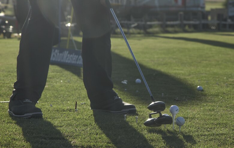 Peter Johncke, trick shot master, performs a trick shot during the Pro and Glow golf tournament hosted by Marine Corps Community Services at the Desert Winds Golf Course aboard the Marine Corps Air Ground Combat Center Twentynine Palms, Calif., June 2, 2017. MCCS invited Johncke to be a golf demonstrator at the event in order to show Combat Center patrons different ways to expand their golfing talents.