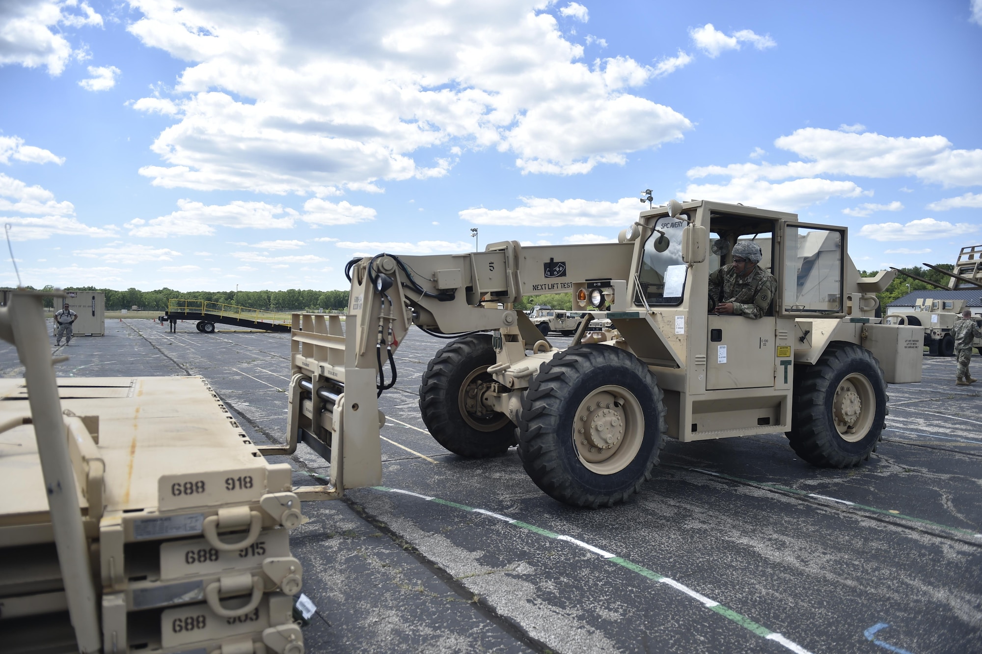 Spc. Matthew Avery, 688th Rapid Port Opening Element, moves equipment to the cargo staging area in preparation to move supplies to the forward distribution node, to establish a theater level logistics flow during Exercise Turbo Distribution 17-02, June 7, 2017, at Battle Creek Air National Guard Base, Mich.  The Joint Task Force-Port Opening element specializes in rapidly establishing hubs for cargo distribution operations worldwide, to include remote or damaged locations, on short notice.  (U.S. Photo by Tech. Sgt. Liliana Moreno/Released)