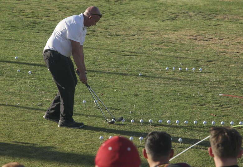Peter Johncke, trick shot master, performs a trick shot during the Pro and Glow golf tournament hosted by Marine Corps Community Services at the Desert Winds Golf Course aboard the Marine Corps Air Ground Combat Center Twentynine Palms, Calif., June 2, 2017. MCCS invited Johncke to be a golf demonstrator at the event in order to show Combat Center patrons different ways to expand their golfing talents.