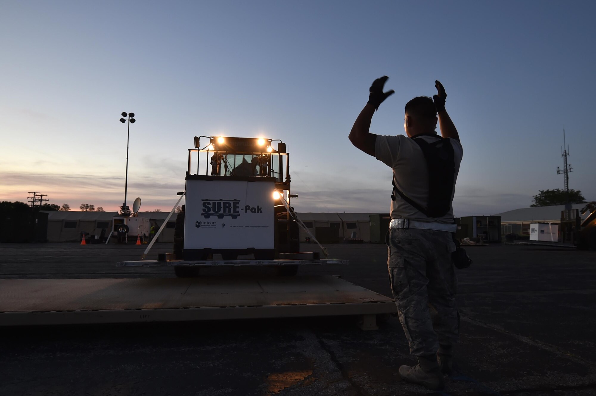 Staff Sgt. Jorge Hernandez, 821st Contingency Response Squadron aerial port supervisor, directs a forklift to the cargo staging area in preparation to move supplies to the forward distribution node, to establish a theater level logistics flow during Exercise Turbo Distribution 17-02, June 7, 2017, at Battle Creek Air National Guard Base, Mich.  The JTF-PO element specializes in rapidly establishing hubs for cargo distribution operations worldwide, to include remote or damaged locations, on short notice.  (U.S. Photo by Tech. Sgt. Liliana Moreno/Released)