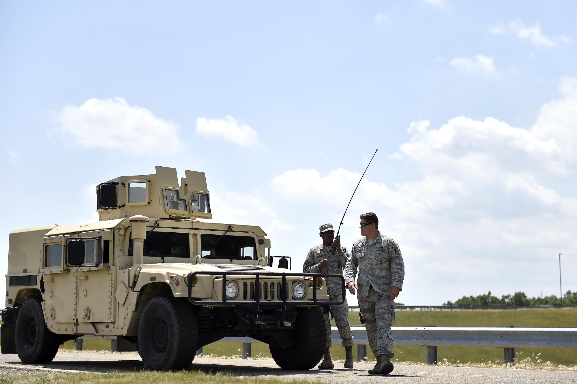 Airman 1st Class Calixto Mariano and Staff Sgt. Steven Armbright, 821st Contingency Response Group security forces, respond to a simulated accident during Exercise Turbo Distribution 17-02, June 9, 2017, at Battle Creek Air National Guard Base, Mich.  Turbo Distribution is used to evaluate mobility operations and expeditionary combat support. Unlike traditional, simulation based exercises, TD provides a dynamic venue with scenarios designed to challenge participants executing complex operations in a deployed environment.  (U.S. Photo by Tech. Sgt. Liliana Moreno/Released)