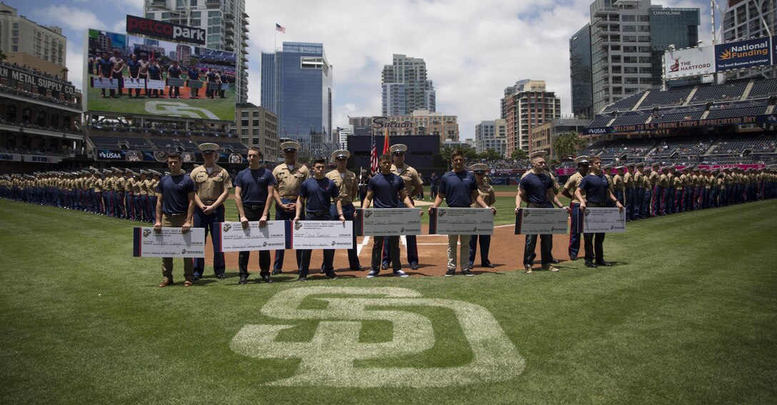 Future Marines from Recruiting Station San Diego take the oath of enlistment and receive NROTC scholarship checks at a pre-game ceremony hosted at Petco Park, San Diego, June 11, 2017. (U.S. Marine Corps Photo by Sgt. Taylor Morton/Released) 