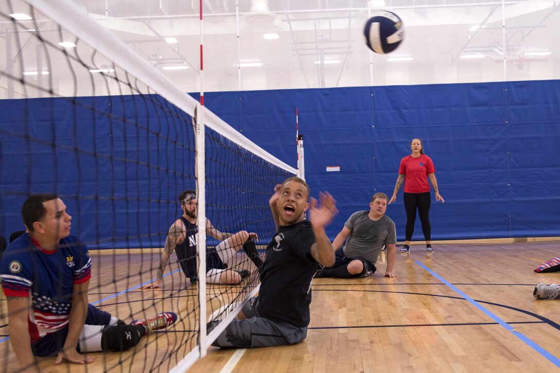 Navy Petty Officer 2nd Class Alan Thomas practices sitting volleyball drills with fellow Team Navy members during a Navy Wounded Warrior Walter Reed Adaptive Sports training camp in Bethesda, Md., June 10, 2017. Navy photo by Petty Officer 2nd Class Charlotte C. Oliver