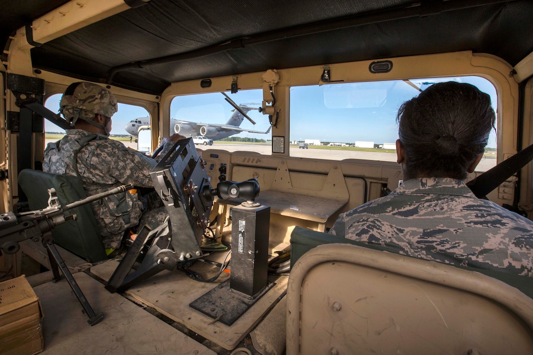Army Spc. Anthony R. Cariola, left, and Air Force Senior Airman Krystin A. Springer-Ince ride in a Humvee onto the flightline before loading it on an Air Force C-17 Globemaster III during a joint mobility exercise at Joint Base McGuire-Dix-Lakehurst, N.J., June 4, 2017. Cariola is assigned to the 851st Transportation Detachment, Army Reserve. Springer-Ince is assigned to the 35th Aerial Port Squadron, 514th Air Mobility Wing. The troops loaded two Humvees and a heavy expanded mobility tactical truck recovery truck onboard an Air Force C-17 Globemaster III. Air Force photo by Master Sgt. Mark C. Olsen
