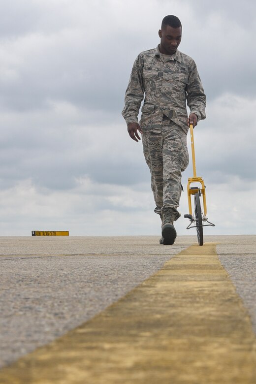 Airman 1st Class Isaiah Davis, 89th Operations Support Squadron airfield manager, measures a flightline marking at Joint Base Andrews, Md., June 7, 2017. Inspecting these markings and making sure they are within regulations ensures pilots can navigate the flightline in a safe manner. (U.S. Air Force photo by Airman 1st Class Valentina Lopez)