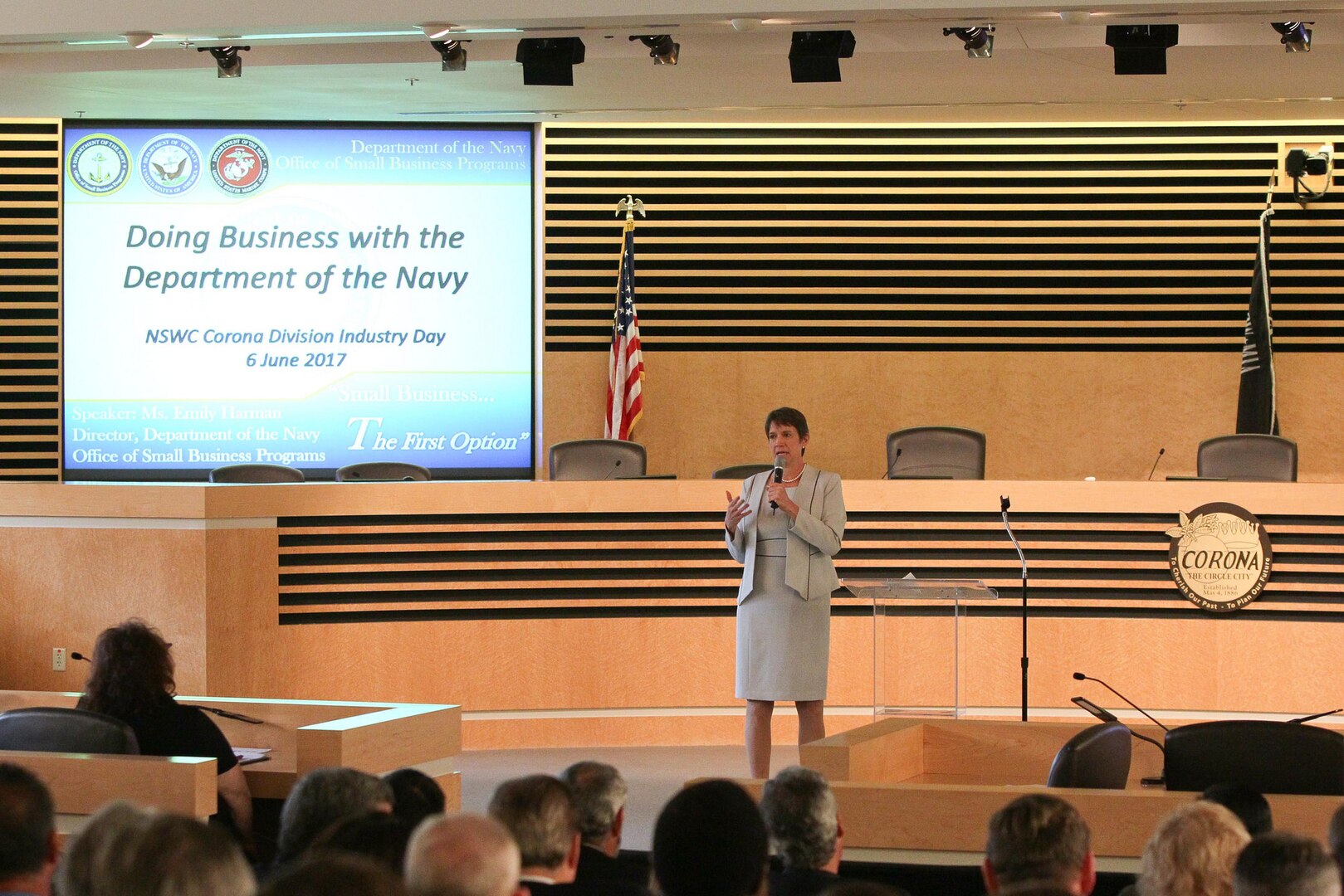 Emily Harman, Department of the Navy Office of Small Business Program director, delivers her keynote address during Industry Day at Corona City Hall. The Naval Surface Warfare Center (NSWC), Corona Division-sponsored event, organized in cooperation with Riverside Community College District Procurement Assistance Center, included a forecast of NSWC Corona future contracting/subcontracting opportunities as well as meet-and-greet sessions for suppliers to network with technical department personnel.