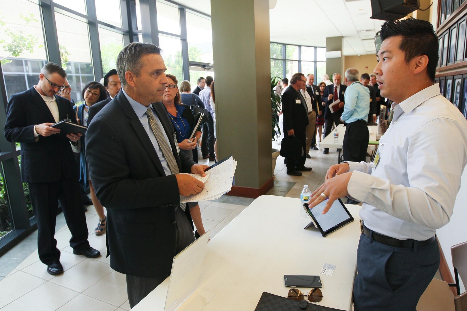 Ken Garber, PM Tec vice president, left, chats with Michael Tao, Naval Surface Warfare Center (NSWC), Corona Division Acquisition and Readiness Assessment Software Development Branch head, chat during Industry Day at Corona City Hall. Organized in cooperation with Riverside Community College District Procurement Assistance Center, the event included a keynote presentation by Emily Harman, Department of the Navy Office of Small Business Program director, a forecast of NSWC Corona future contracting/subcontracting opportunities as well as a series of meet-and-greet sessions for suppliers to network with technical department personnel.
