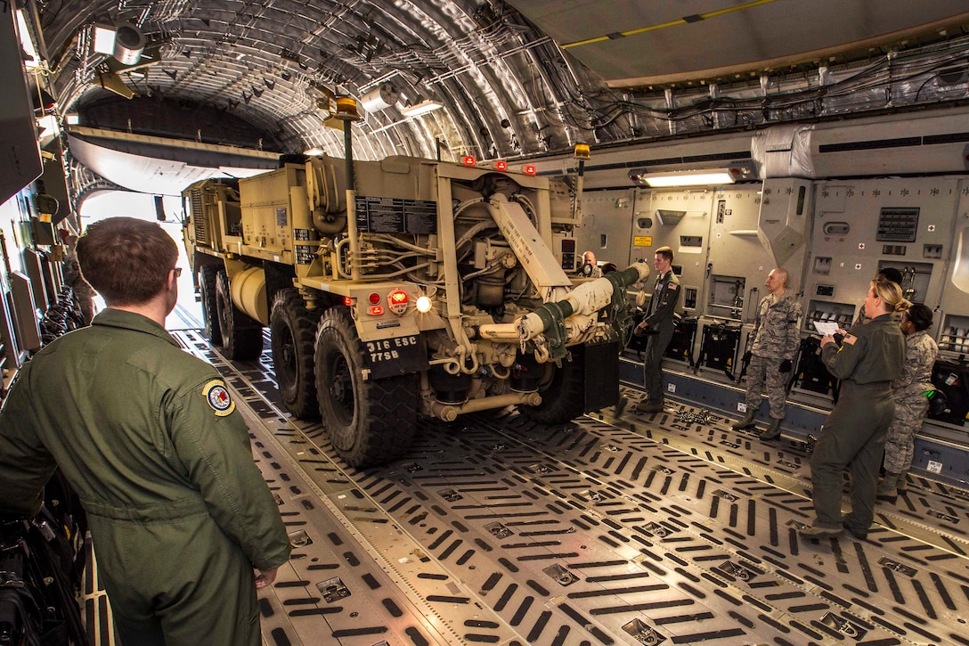 Airmen monitor the loading of a tactical recovery truck inside an Air Force C-17 Globemaster III aircraft during a joint mobility exercise at Joint Base McGuire-Dix-Lakehurst, N.J., June 4, 2017. Air Force photo by Master Sgt. Mark C. Olsen