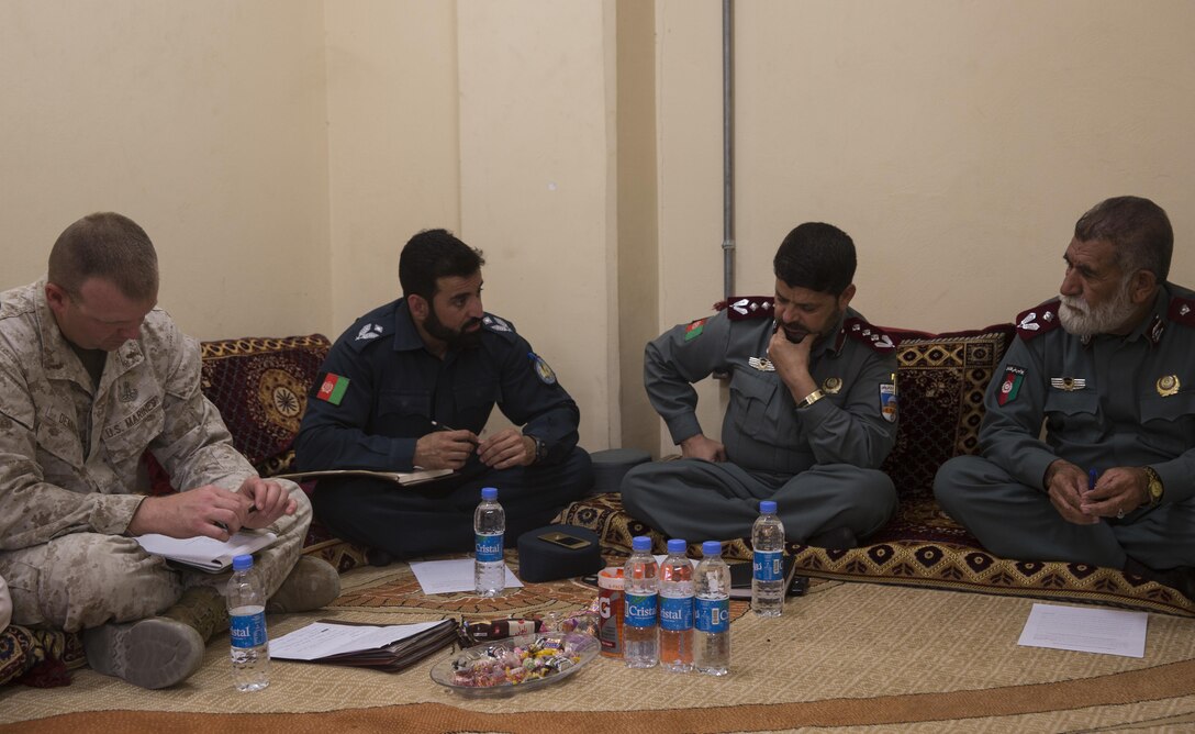 A U.S. Marine advisor with Task Force Southwest holds a training meeting with his Afghan National Police counterparts at Bost Airfield, Afghanistan, May 15, 2017, where they discussed classes that the advisors will teach over the next few weeks. The classes will consist of the various explosive ordnance disposal techniques as well as how to properly use their EOD robot and vallon metal detectors. Task Force Southwest, comprised of approximately 300 Marines and Sailors from II Marine Expeditionary Force, are training, advising and assisting the Afghan National Army 215th Corps and the 505th Zone National Police. (U.S. Marine Corps photo by Sgt. Justin T. Updegraff)