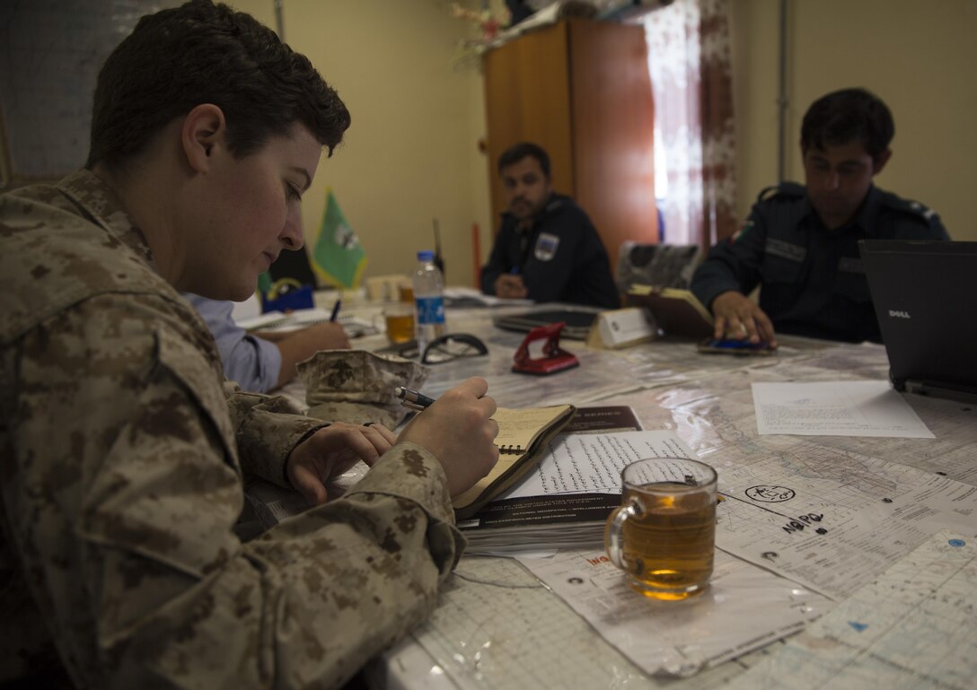 A U.S. Marine advisor with Task Force Southwest jots down notes during a meeting at Bost Airfield, Afghanistan, May 16, 2017. The advisors discussed the various checkpoints in the area and ensured that the proper steps were being taken to promote security in the region. Task Force Southwest, comprised of approximately 300 Marines and Sailors from II Marine Expeditionary Force, are training, advising and assisting the Afghan National Army 215th Corps and the 505th Zone National Police. (U.S. Marine Corps photo by Sgt. Justin T. Updegraff)