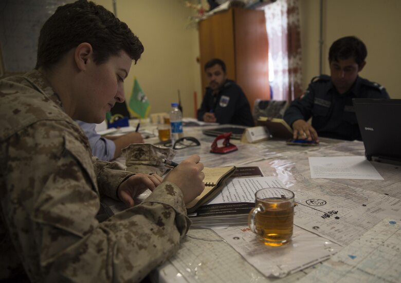 A U.S. Marine advisor with Task Force Southwest jots down notes during a meeting at Bost Airfield, Afghanistan, May 16, 2017. The advisors discussed the various checkpoints in the area and ensured that the proper steps were being taken to promote security in the region. Task Force Southwest, comprised of approximately 300 Marines and Sailors from II Marine Expeditionary Force, are training, advising and assisting the Afghan National Army 215th Corps and the 505th Zone National Police. (U.S. Marine Corps photo by Sgt. Justin T. Updegraff)