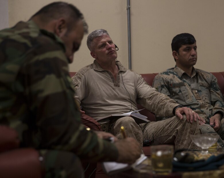 Brig. Gen. Roger Turner, center, commanding general of Task Force Southwest, listens during a security meeting at Bost Airfield, Afghanistan, May 20, 2017. Gen. Turner, and the key leaders, discussed defensive and offensive operations in the area. Task Force Southwest, comprised of approximately 300 Marines and Sailors from II Marine Expeditionary Force, are training, advising and assisting the Afghan National Army 215th Corps and the 505th Zone National Police. (U.S. Marine Corps photo by Sgt. Justin T. Updegraff)