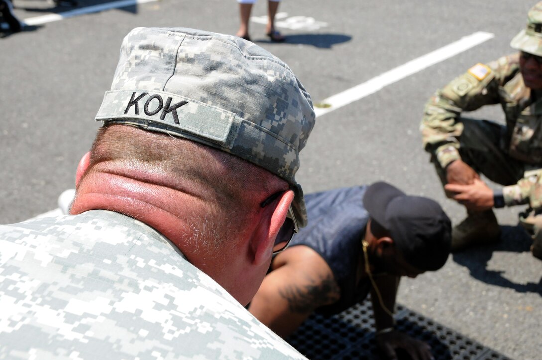 Maj. Gen. Troy D. Kok, commanding general of the U.S. Army Reserve’s 99th Regional Support Command, headquartered at Joint Base McGuire-Dix-Lakehusrt, New Jersey, counts push-ups June 10 at the GoArmy experience during “Army Day At The Races” at Old Bridge Township Raceway Park in Englishtown, New Jersey.  Kok was at the event to help celebrate the Army’s 242nd birthday during the National Hot Rod Association’s Summernationals.