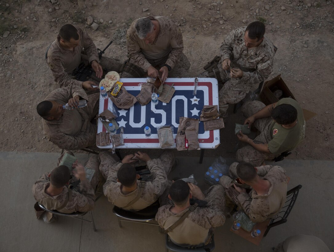 Brig. Gen. Roger Turner, top/center, commanding general of Task Force Southwest, enjoys an MRE, meal ready-to-eat, dinner with Marines at Bost Airfield, Afghanistan, May 20, 2017. Gen. Turner asked for feedback on what should be changed or added at Bost in regards to force protection, living conditions and morale. Task Force Southwest, comprised of approximately 300 Marines and Sailors from II Marine Expeditionary Force, are training, advising and assisting the Afghan National Army 215th Corps and the 505th Zone National Police. (U.S. Marine Corps photo by Sgt. Justin T. Updegraff)