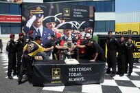 Maj. Gen. Troy D. Kok, commanding general of the U.S. Army Reserve’s 99th Regional Support Command, headquartered at Joint Base McGuire-Dix-Lakehusrt, New Jersey, helps cut the cake June 10 with the help of Don Schumacher Racing.  The cake cutting was part of “Army Day At The Races” at Old Bridge Township Raceway Park in Englishtown, New Jersey.  Tony Schumacher (immediate left of Kok) drives the U.S. Army top fuel dragster.  Members of the Army’s Golden Knights Parachute Team are also pictured.