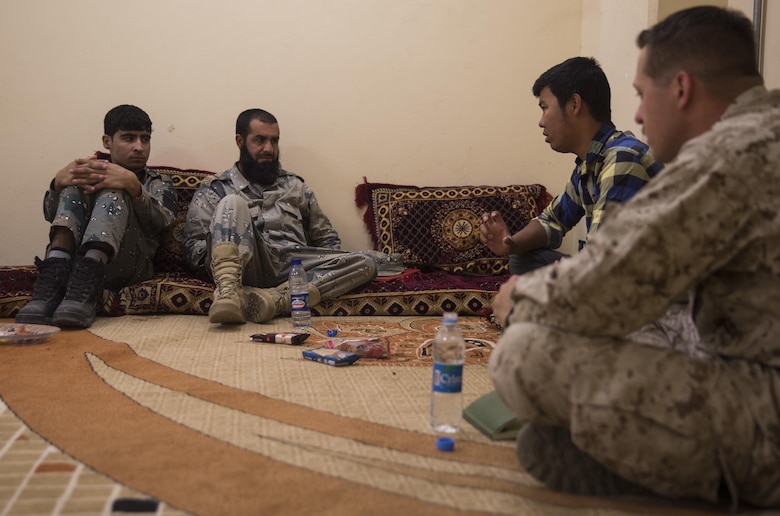 A U.S. Marine advisor with Task Force Southwest goes over what will be covered during the bi-weekly course with his Afghan National Police counterparts at Bost Airfield, Afghanistan, May 18, 2017. During the next few weeks, they will learn various explosive ordnance disposal techniques as well as how to properly use their EOD robot and vallon metal detectors. Task Force Southwest, comprised of approximately 300 Marines and Sailors from II Marine Expeditionary Force, are training, advising and assisting the Afghan National Army 215th Corps and the 505th Zone National Police. (U.S. Marine Corps photo by Sgt. Justin T. Updegraff)
