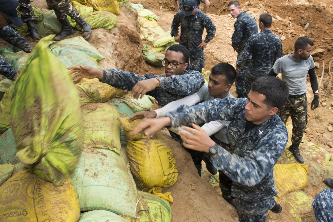 Sailors assigned to the USS Lake Erie work with Sri Lankan marines to repair levees in Matara, Sri Lanka, June 12, 2017, during humanitarian assistance operations following severe flooding and landslides in the country. Navy photo by Petty Officer 2nd Class Joshua Fulton