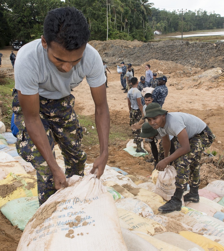 Sri Lankan marines work with U.S. sailors to repair a levee in Matara, Sri Lanka, June 12, 2017, during humanitarian assistance operations following severe flooding and landslides in the country. Navy photo by Petty Officer 2nd Class Joshua Fulton