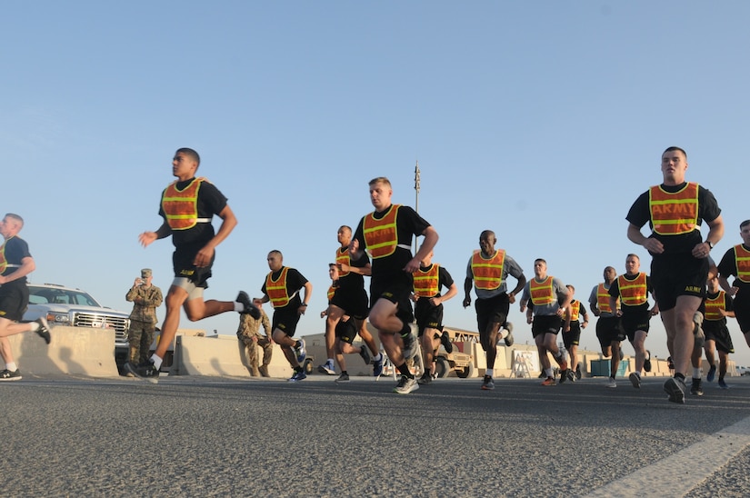U.S. Army Central Best Warrior candidates take off at the starting point of the two-mile run as the last portion of the Army Physical Fitness Test, Camp Buehring, Kuwait, May 23. Competitors had a short break following the APFT before having to traverse the air assault obstacle course. (Photo by U.S. Army Sgt. Kelly Gary, 29th Infantry Division Public Affairs)