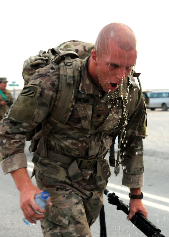 Spc. Zachary Elenchin, a Soldier representing 3rd Medical Command, in the U.S. Army Central Best Warrior competition, turns around at the six-mile mark of the ruck march at Camp Buehring, Kuwait, May 24. Competitors had to complete a 12-mile ruck march as one of four events testing physical fitness and fortitude. (Photo by U.S. Army Sgt. Kelly Gary, 29th Infantry Division Public Affairs)