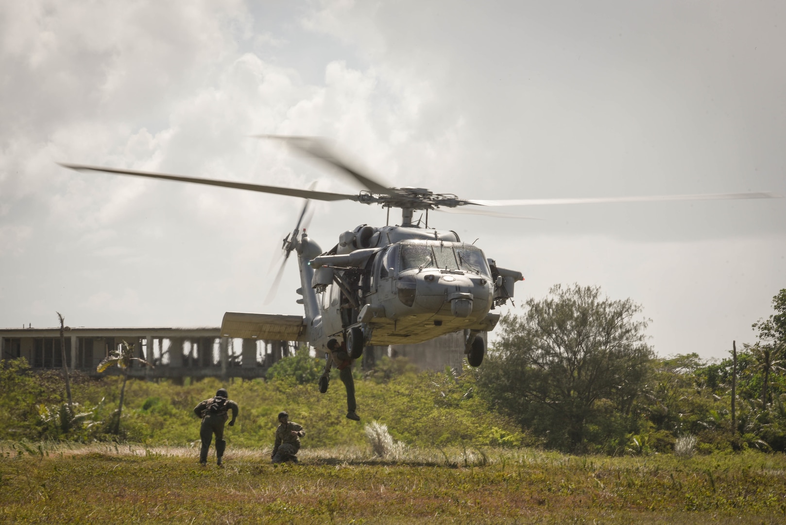 A U.S. Airman from the 9th Expeditionary Bomb Squadron descends from a U.S. Navy MH-60 Seahawk, assigned to Helicopter Sea Combat Squadron Two-Five, during a combat search and rescue training exercise June 5, 2017, at Andersen South, Guam. Service members from Task Force Talon, HSC-25, and the 36th Wing joined together to practice survival, evasion, resistance and escape procedures, emergency evacuation techniques and quick reaction force training. This is the first time these units participated in a combat search and rescue exercise together on Guam. 