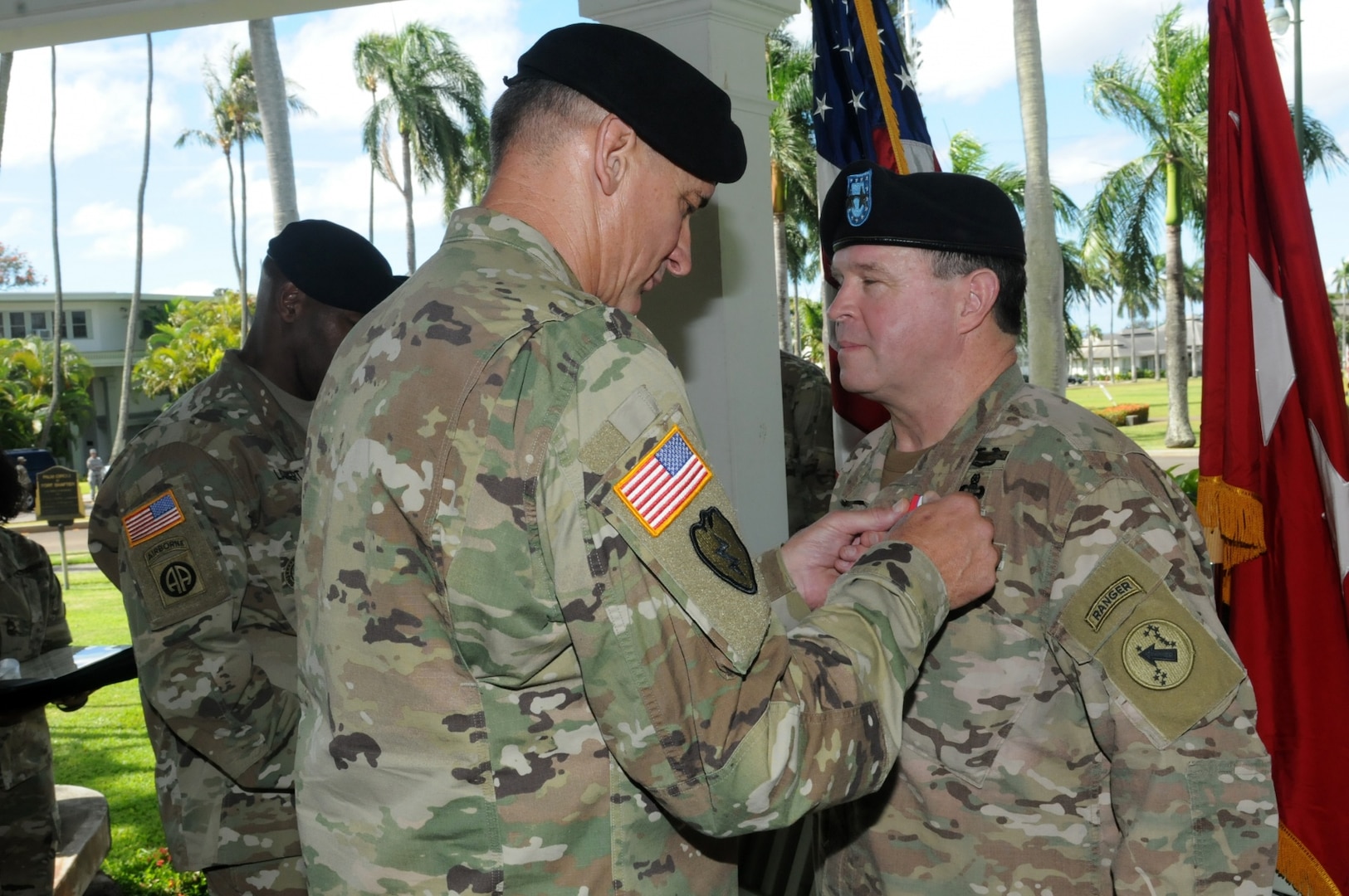 U.S. Army Pacific Commanding General Gen. Robert B. Brown (left) presents Maj. Gen. Mark J. O'Neil, Chief of Staff, U. S. Army Pacific, with the Distinguished Service Medal "For Exceptionally Meritorious Service In A Duty Of Great Responsibility" at a Flying "V" ceremony held at historic Palm Circle, Fort Shafter, Hawaii, June 9. The Flying "V" ceremony was held to honor O'Neil for his distinguished service as he prepares to depart USARPAC. The "V" refers to the way the colors are posted during the ceremony, which is V-shaped.