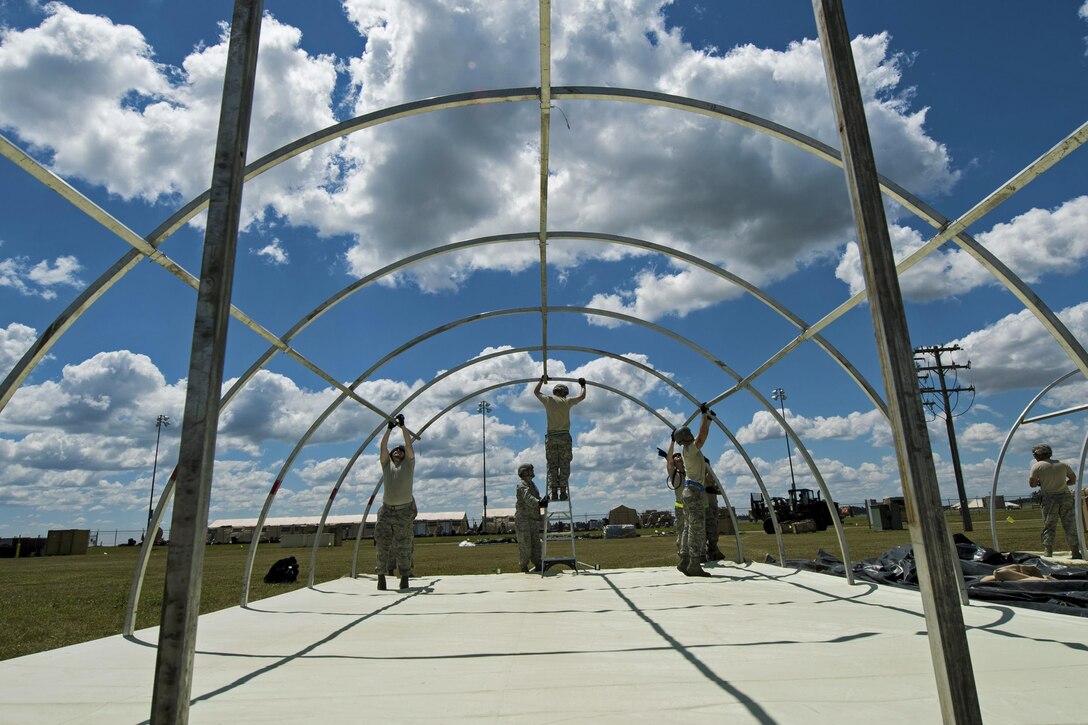 Airmen put up a tent at Battle Creek Air National Guard Base, Mich., June 7, 2017, during exercise Turbo Distribution 17-2. The U.S. Transportation Command exercise aims to assess the Joint Task Force Port Opening's ability to deliver and distribute cargo during humanitarian and disaster relief operations. The airmen are assigned to the 821st Contingency Response Group. Air Force photo by Airman 1st Class Gracie I. Lee